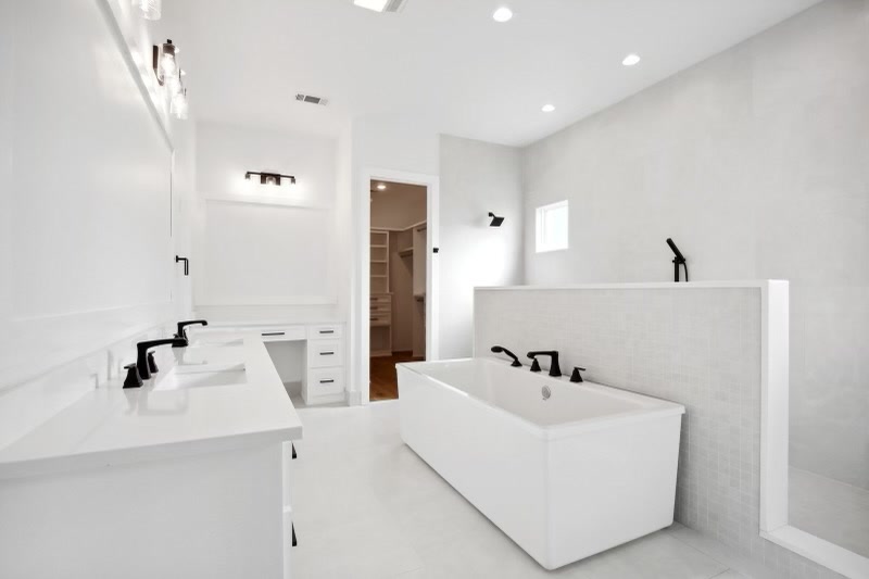 All-white primary bath with soaking tub