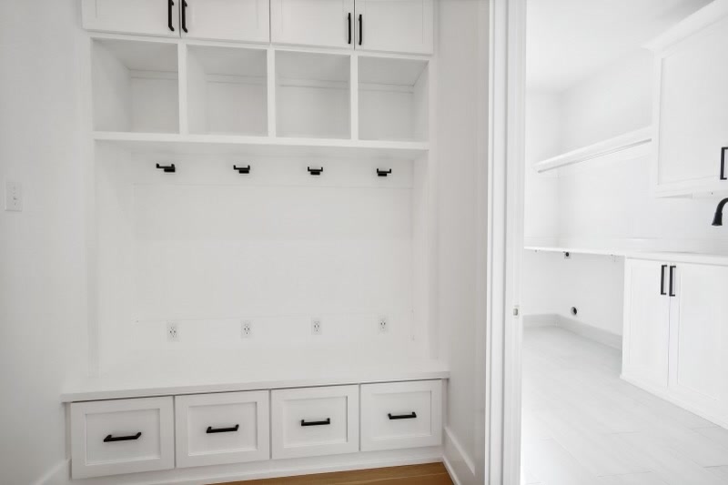 Mudroom with built-in cubbies, hooks, and bench drawers
