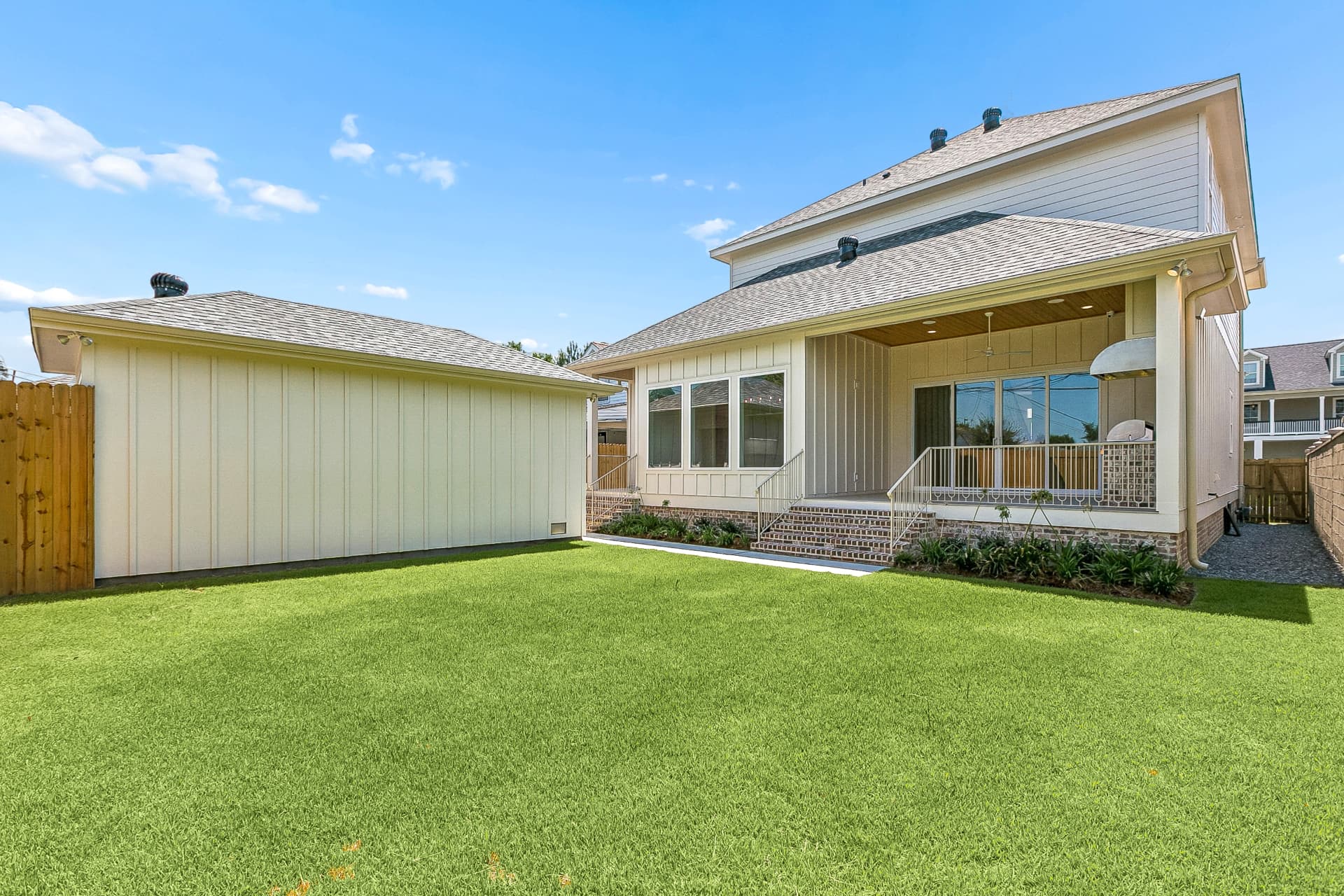 Backyard with covered rear porch and detached garage