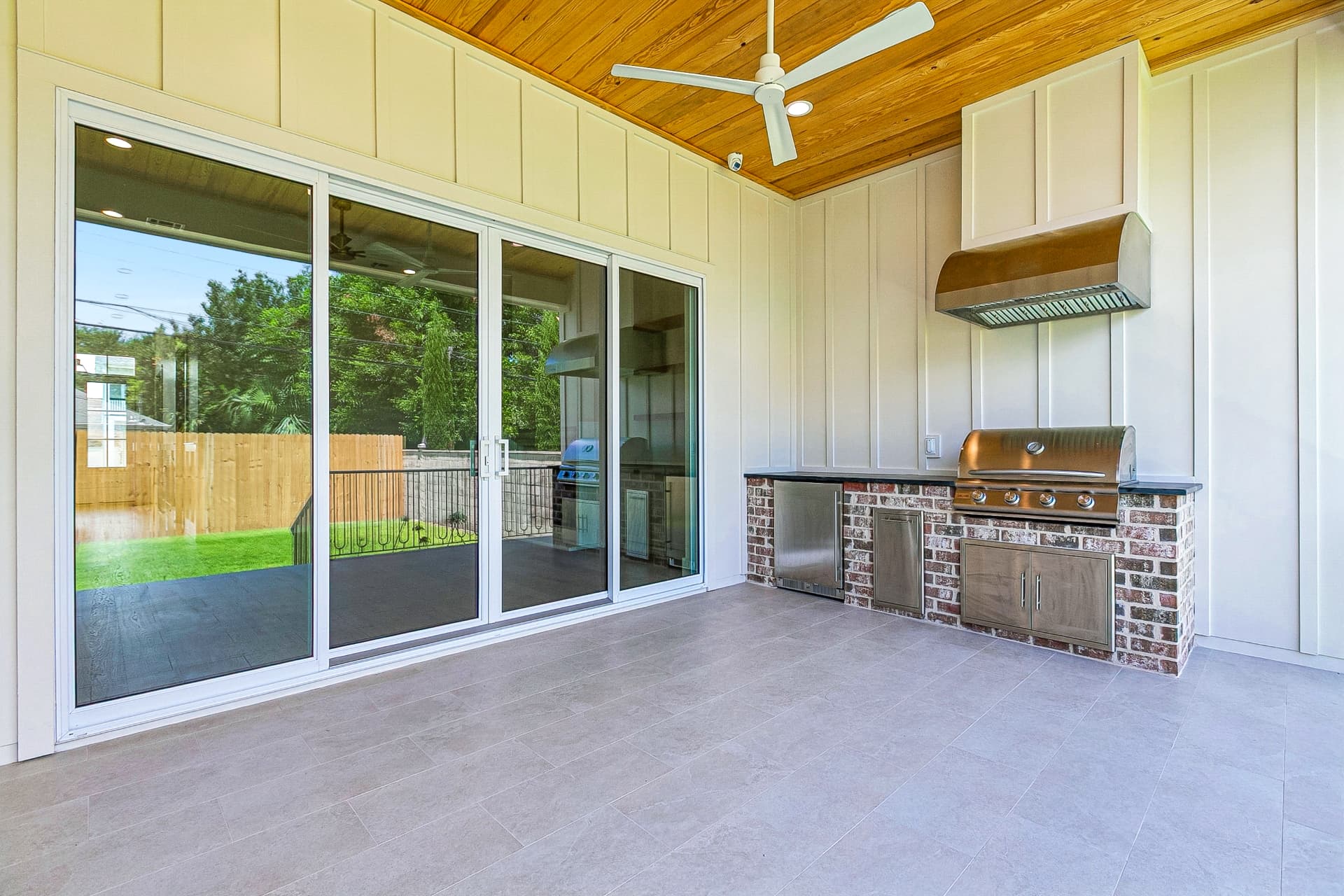 Covered patio with outdoor kitchen and grill