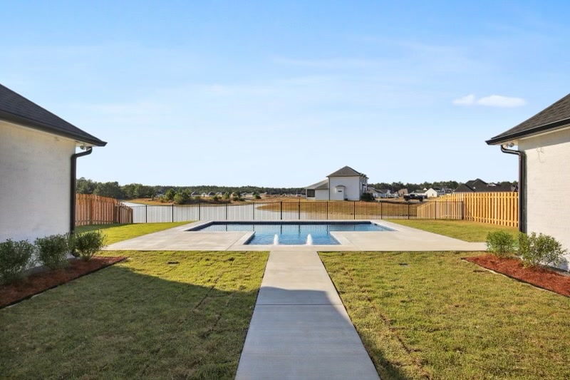 Backyard swimming pool with fountain jets