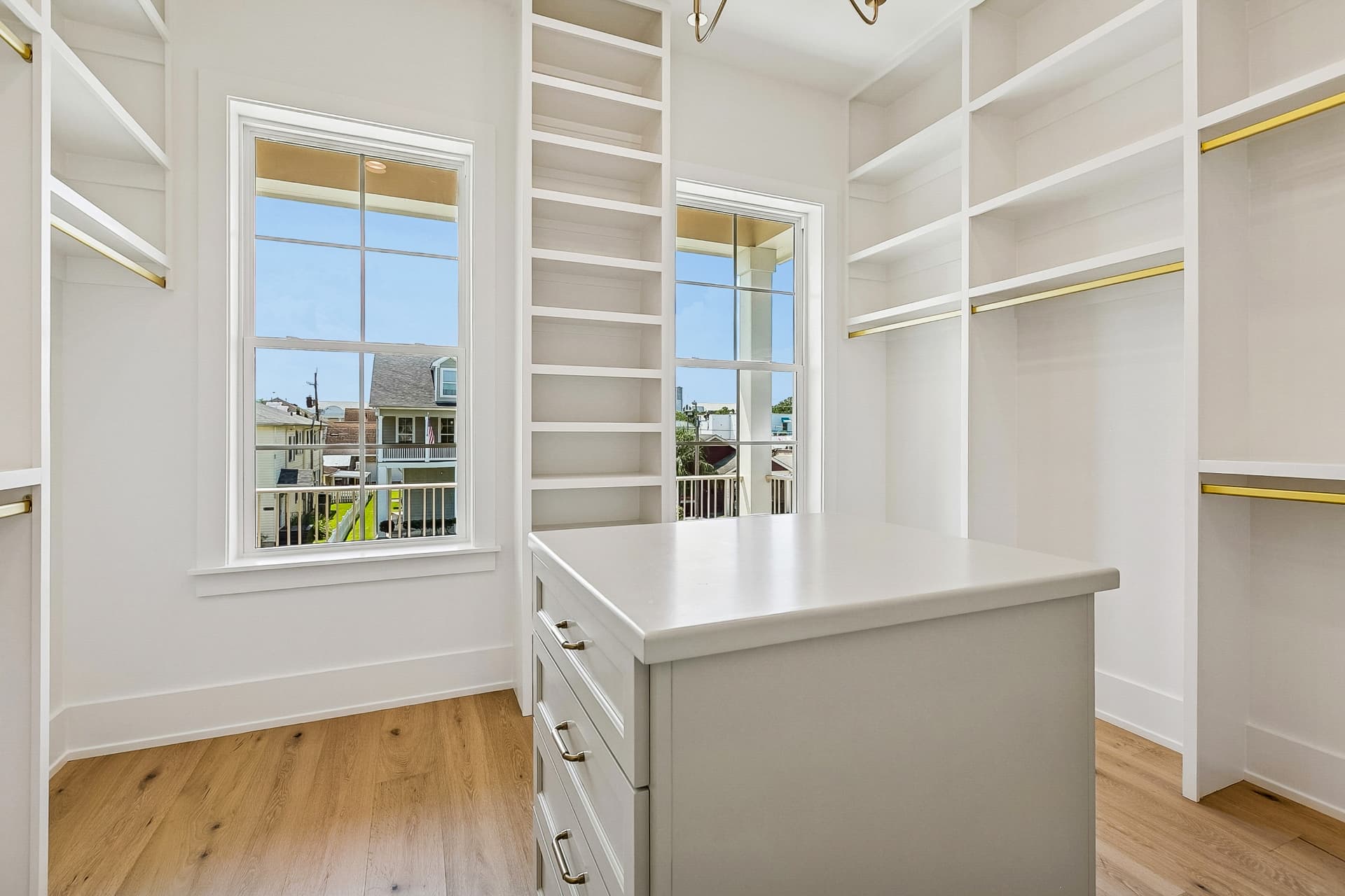 Walk-in closet with built-in shelving and center island