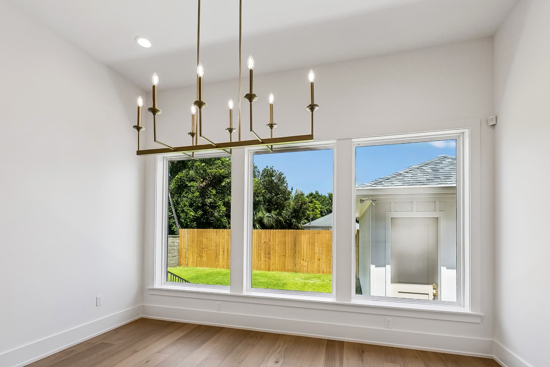 Dining room with brass chandelier and garden windows