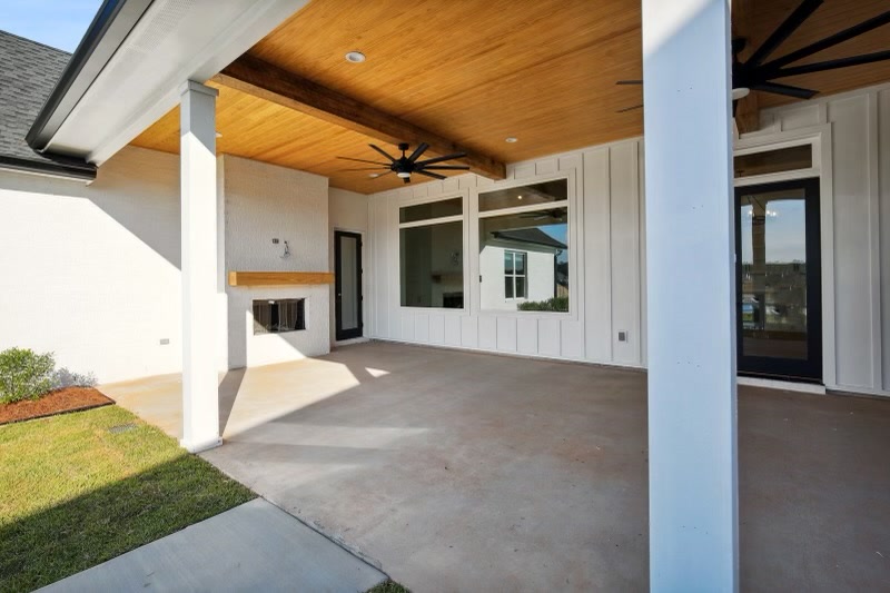 Covered patio with fireplace and wood ceiling